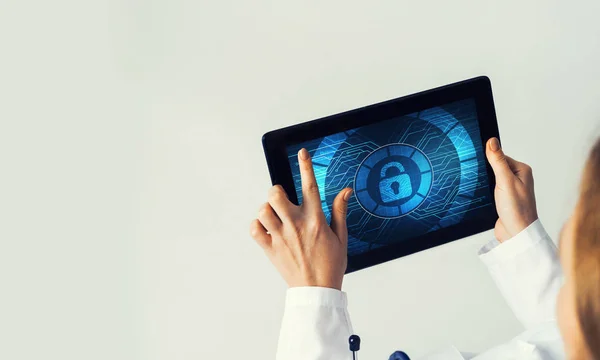 Tablet pc device with security padlock on screen in hands of doctor