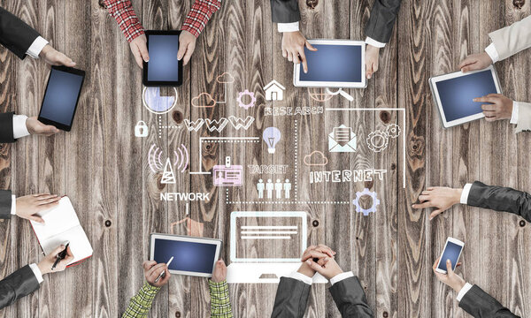 Group of people with devices in hands working together as symbol of networking and communication