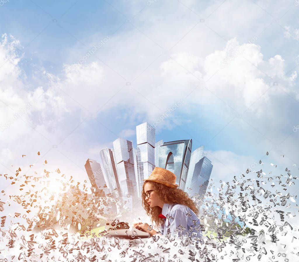 Young woman writer in hat and eyeglasses using typing machine while sitting at the table among flying letters with floating city island and cloudy skyscape on background.