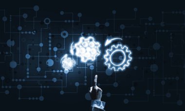 İş adamının eli dişli mekanizmasını işaret ediyor.