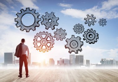 Modern şehre bakan ve vites düzeneği çizen işadamlarının arka planı