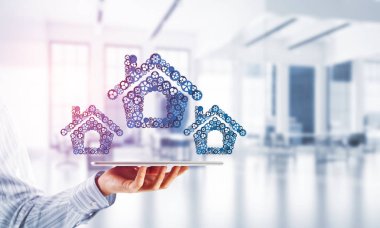 İşadamlarının elinde tablet tablet ve bağlı viteslerden oluşan tabela var. Karışık ortam