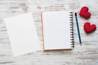 Kalpler ve ahşap masa üzerinde boş not defteri.