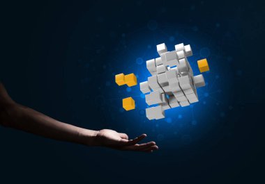 Yeniliğin sembolü olarak insan eli küp figürüne yakın olmak. Karışık ortam.