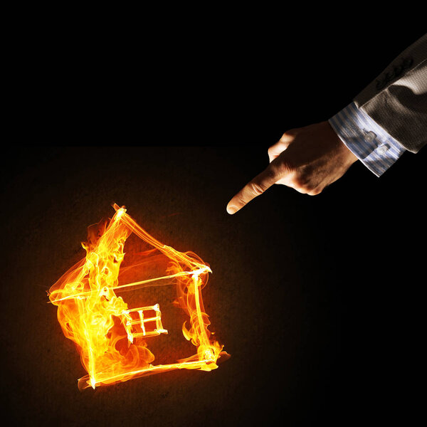 Fire house glowing icon and hand on dark background