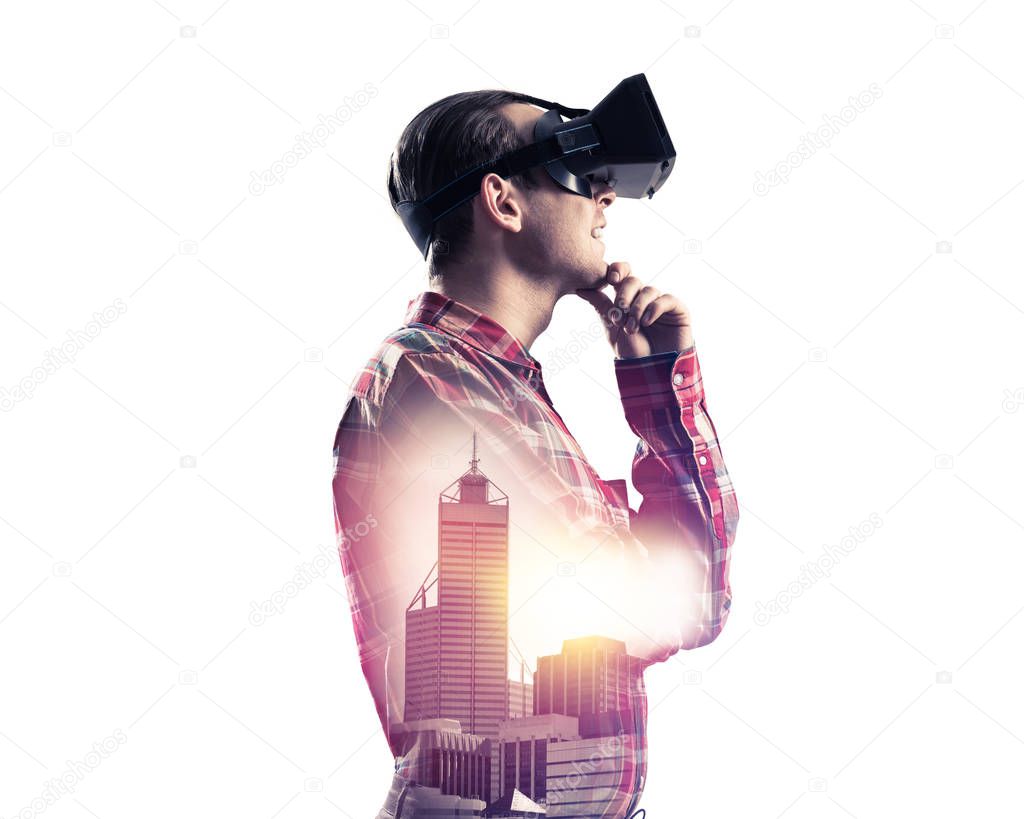 Young man with virtual reality headset or 3d glasses over cityscape background