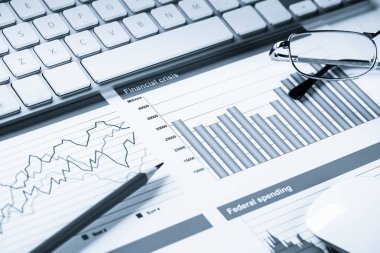 Klavye fareli iş yeri ve grafik ve diyagramlı kağıtlar