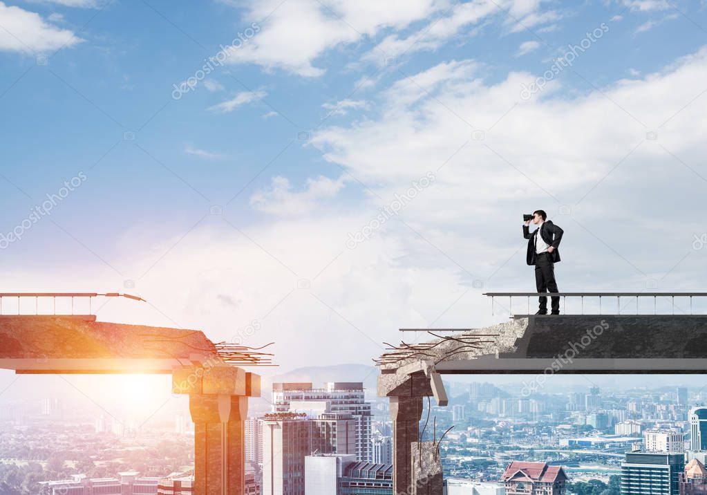 Businessman in suit looking in binoculars while standing on broken bridge with cityscape and sunlight on background. 3D rendering.