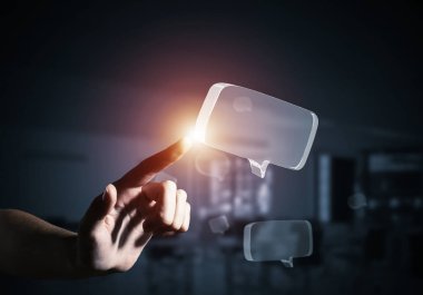 Kadın eli, parlak cam konuşma baloncuğuna dokunuyor. Karışık ortam