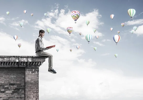 Young Shocked Man Student Sitting Building Top Red Book Hands — Stock Photo, Image