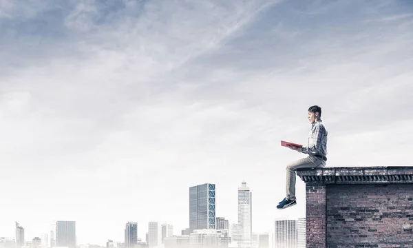 Young Man Casual Sitting Parapet Red Book Hands — Stock Photo, Image