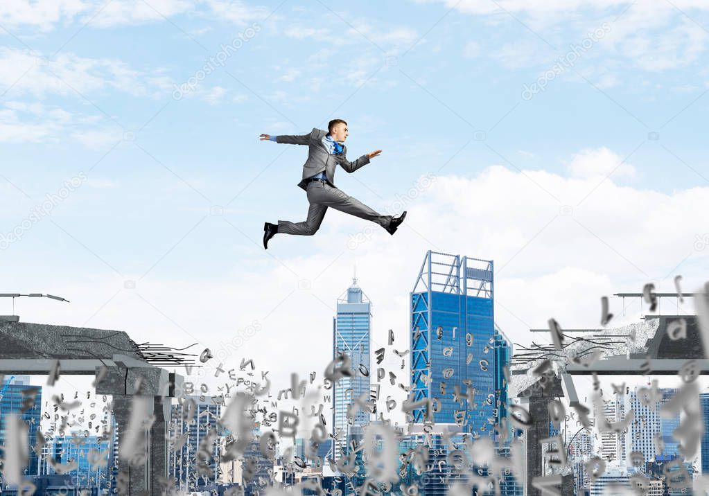Businessman jumping over gap with flying letters in concrete bridge as symbol of overcoming challenges. Cityscape on background. 3D rendering.