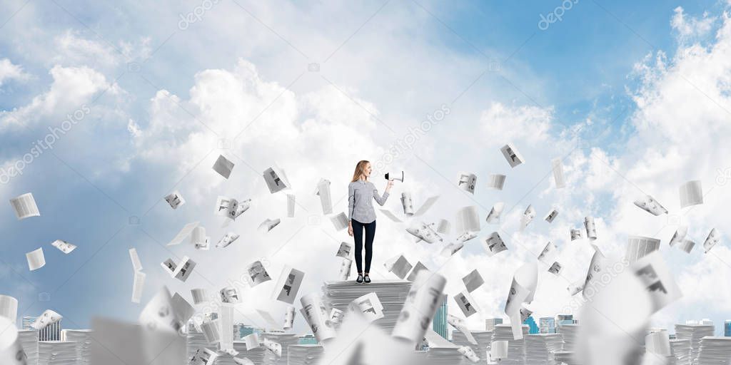 Woman in casual clothing standing among flying papers with speaker in hand and with skyscape on background. Mixed media.