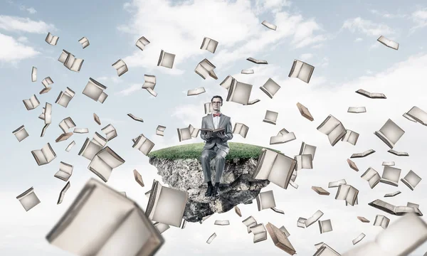Komik adam kırmızı gözlük ve yüzen ada üzerinde oturan ve kitap okuma takım elbise