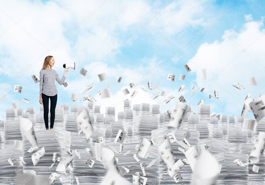 Woman in casual clothing standing on pile of documents among flying papers with speaker in hand with cloudly skyscape on background. Mixed media.