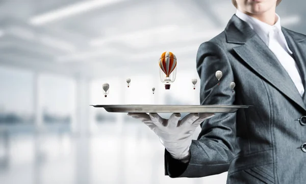 Hand of waiter presenting balloons on tray. — Stock Photo, Image