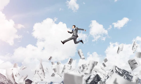 Businessman in suit running in the air among flying papers as symbol of active life position. Skyscape and nature view on background. 3D rendering.
