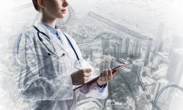 Conceptual image of confident medical industry employee writing in notebook with city view and medical equipment on background. Double exposure. Young female doctor