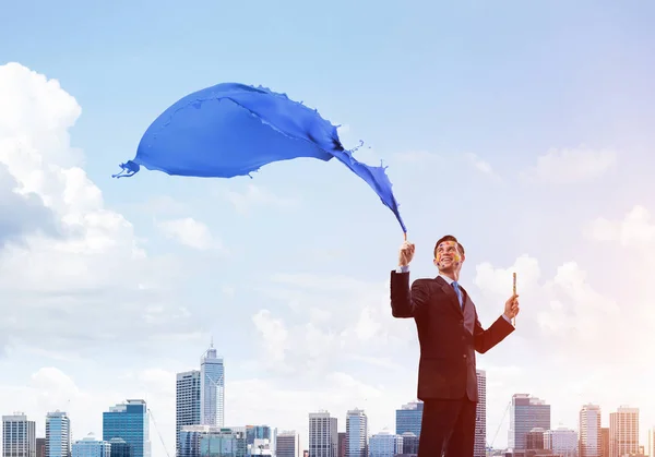 Successful Businessman Black Suit Gesturing Smiling While Standing Blue Coloured — Stock Photo, Image