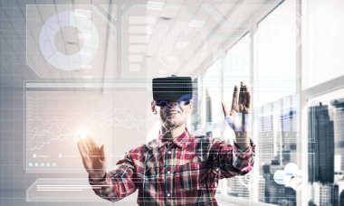 Giyen adam ekose desenli gömlek ve sanal kulaklık medya ekran Masası ile çalışma