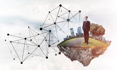 Mavi gökyüzünde yüzen yeşil Adası üzerinde zarif işadamı