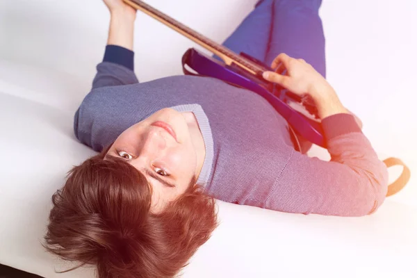 Joyful Happy Good Looking Man Holding Guitar Smiling While Playing — Stock Photo, Image