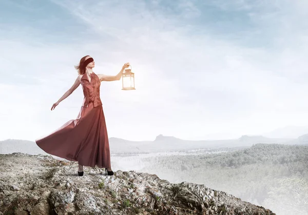 Attractive girl muse with old lantern in hand at summer day — Stock Photo, Image