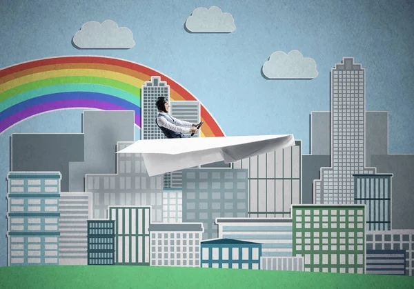 Aircraft pilot sitting in paper plane and holding steering wheel. Aviator driving paper plane on background of city illustration. Cityscape with rainbow and high skyscrapers and office buildings.