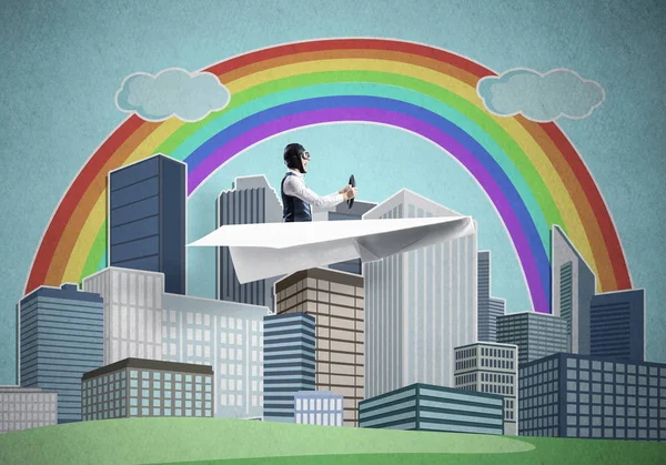 Aircraft pilot sitting in paper plane and holding steering wheel. Aviator driving paper plane on background of city illustration. Cityscape with rainbow and high skyscrapers and office buildings.