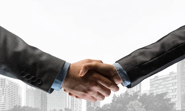 Business handshake as idea for unity and cooperation or greeting. Mixed media — Stock Photo, Image