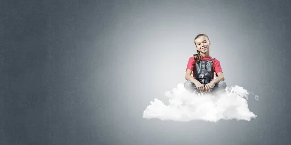 青色の背景の雲に座っているかわいい子供女の子 — ストック写真