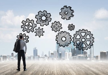 Modern şehre bakan ve vites düzeneği çizen işadamlarının arka planı