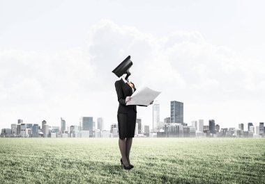 Zarif bir iş kadını kafasında değil, elinde kağıtlar ve kamerayla dışarıda.