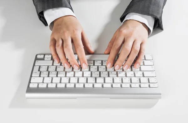 Close-up van zakenvrouw hand typen op toetsenbord met muis op houten tafel — Stockfoto