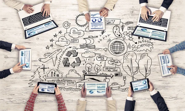 Top view of businesspeople sitting at table and using gadgets — Stock Photo, Image