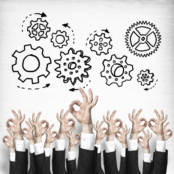 Group of hands of businesspeople showing gestures on wooden background