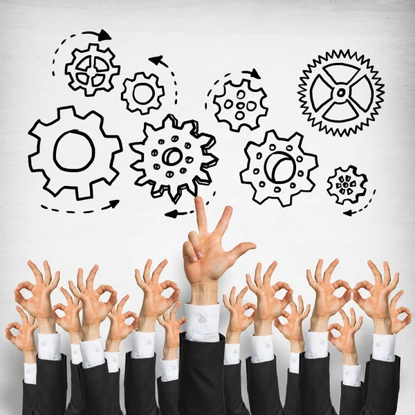 Group of hands of businesspeople showing gestures on wooden background