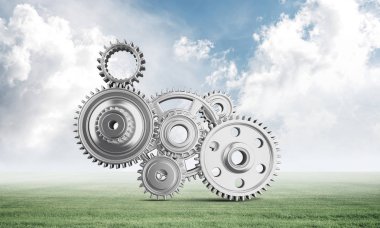 Yeşil çayır üzerinde dişli tekerlekler ile soyut mekanizma