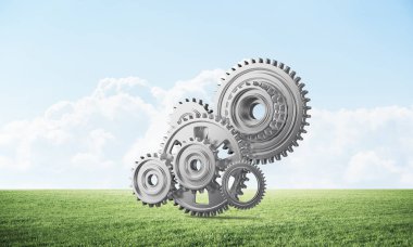 Yeşil çayır üzerinde dişli tekerlekler ile soyut mekanizma