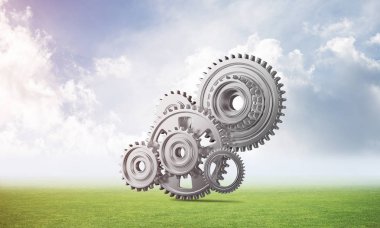 Yeşil çayır üzerinde dişli tekerlekler ile soyut mekanizma