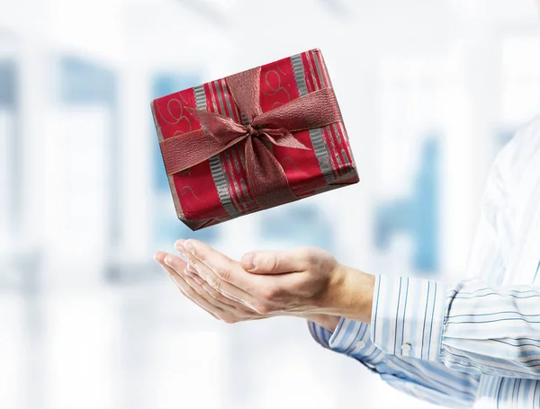 Concept of xmas or celebration with present box in male palms. M — Stock Photo, Image