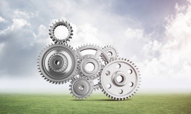 Yeşil çayır üzerinde dişli tekerlekler ile soyut mekanizma