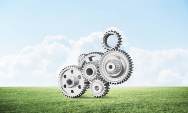 Yeşil çayır üzerinde dişli tekerlekler ile soyut mekanizma