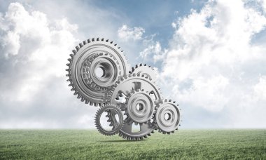 Yeşil çayır üzerinde dişli tekerlekler ile soyut mekanizma
