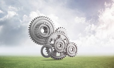 Yeşil çayır üzerinde dişli tekerlekler ile soyut mekanizma