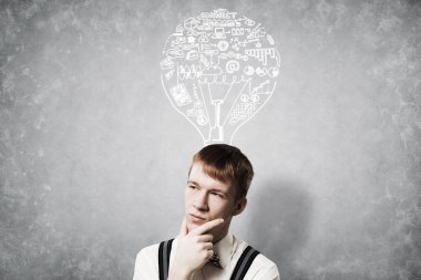 Redhead student thinking about some problem. Clever boy on background of grey wall with idea lightbulb sketch drawing overhead. Young businessman wears shirt and suspenders. New idea generation. clipart