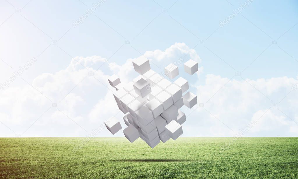Abstract flying white cubes on green meadow