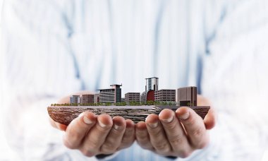 Şehir tasarımının erkek avuçlarında sunduğu inşaat ve mühendislik kavramı. Karışık ortam