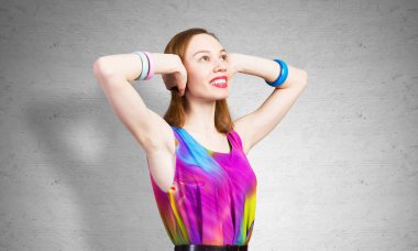 Kızıl saçlı güzel kız elleriyle kulaklarını kapatıyor.