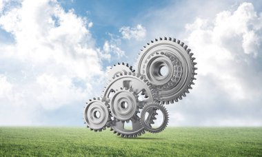 Yeşil çayır üzerinde dişli tekerlekler ile soyut mekanizma